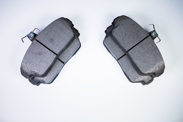 Brake pads disc brakes on a passenger car on a gray background. New spare parts maintenance service...