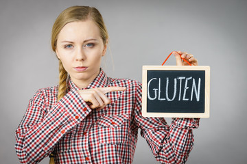 Woman holding board with gluten sign