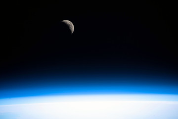 Obraz na płótnie Canvas Orbital dawn from the space station. Moon. Blue glow. Elements of this image furnished by NASA.