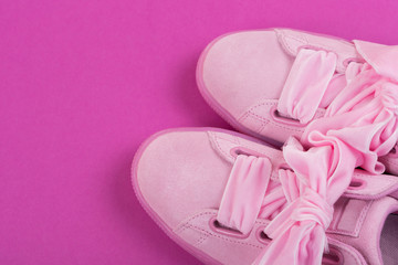 pink female shoes stand on a bright pink background, concept