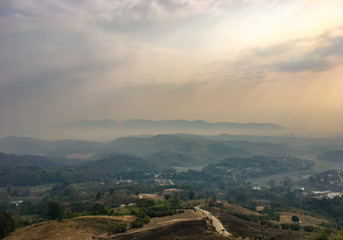 Fototapeta na wymiar The landscape of mountains is full of clouds and fog. A top view of the haze in the mountains And fog in the morning at Doi Sako Mountain, Chiang Saen, Thailand.