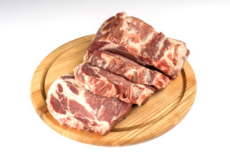 Fresh raw pork neck on wooden board isolated on white. Pork slises.