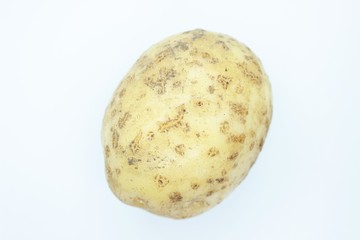 Raw beautiful potato is located on a white background