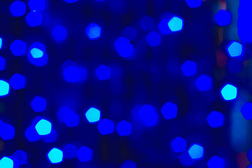 Festive blue bokeh garland, blurred background. Merry Christmas, happy holiday, colorful lights,...