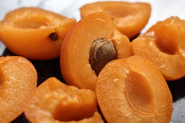 Fresh apricot halves on granite table