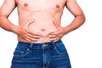 Naklejka premium Overweight man with hand holding fat belly.Overweight man pinches the excess fat that he has around his waist.Isolated on white background.