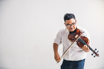 Fototapeta na wymiar Symphony orchestra on white background, hands playing violin. Male violinist playing classical music on violin. Talented violinist and classical music player solo performance.
