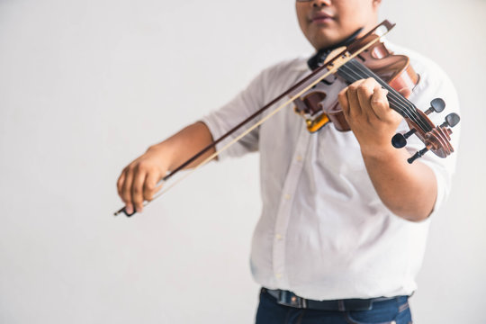 Symphony Orchestra On White Background, Hands Playing Violin. Male Violinist Playing Classical Music On Violin. Talented Violinist And Classical Music Player Solo Performance.