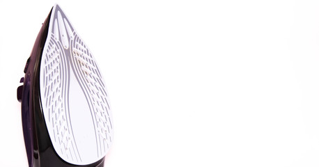 The iron is upright. modern with steam, steam boost, ceramic teflon sole on a white background.  Macro