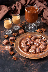Tasty chocolate candy, chocolate  liqueur and cocoa drink
