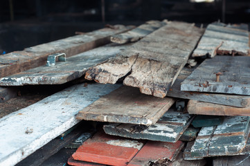 A pile of wooden planks from old houses stacked for burning.