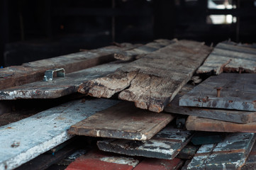 A pile of wooden planks from old houses stacked for burning.