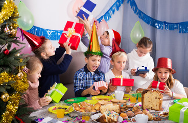 Children exchanging Christmas gifts