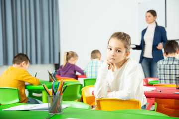 Fototapeta premium Upset girl in schoolroom