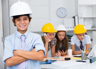 Teen boy in color helmet builder
