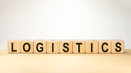 word of logictics on wooden blocks with natural background. Logistics and transportation management ideas and Industry business commercial concept.