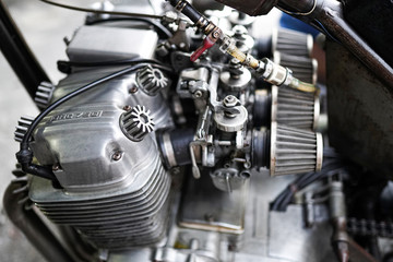Fototapeta na wymiar Old motorcycle engine and engine oil stains. Motorcycle engine repair.