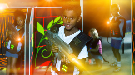 Happy african preteen boy with laser pistol