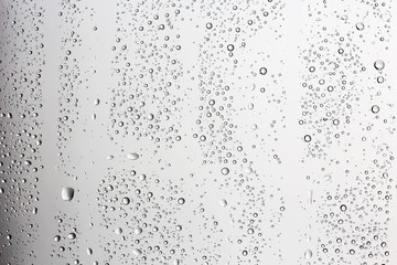 Naklejka na ściany i meble white isolated background water drops on the glass / wet window glass with splashes and drops of water and lime, texture autumn background