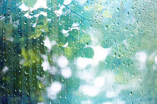 summer rain wet glass / abstract background landscape on a rainy day outside the window blurred background