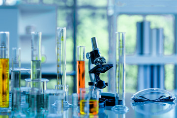 Test tube, glassware and microscope on the table in laboratory