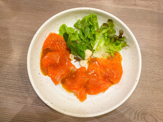 Fresh salmon slices with spicy sauce