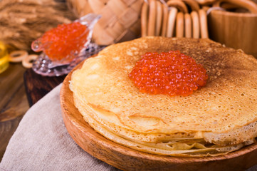 Shrovetide Maslenitsa Week festival meal. Stack of russian pancakes with red caviar. Rustic style, free space for text.