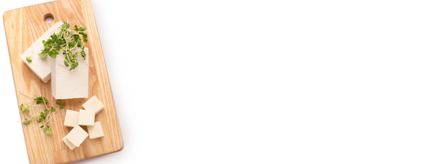 Yummy tofu cubes on wooden board top view