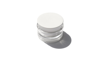 Cosmetic cream in a jar with sunlight on white background