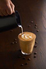 Cup of latte or Cappuccino on table in cafe.