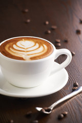 Cup of latte or Cappuccino on table in cafe.