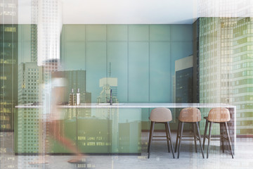 Young girl walking in green kitchen with bar