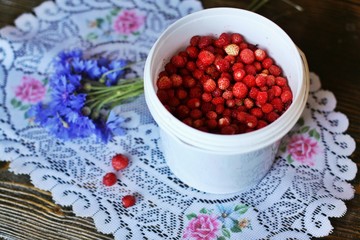 White small bucket with delicious strawberries. Top view