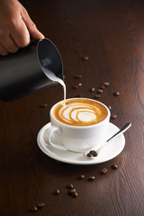 Cup of latte or Cappuccino on table in cafe.