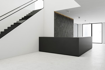 Reception desk in office hall with stairs