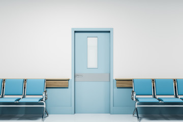 Row of blue chairs in empty hospital corridor