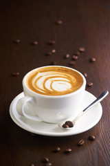 Cup of latte or Cappuccino on table in cafe.