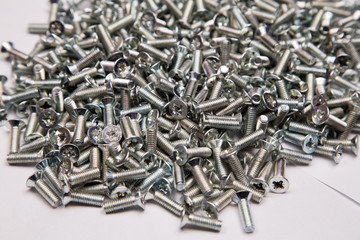  M6 metal screws galvanized white in bulk closeup in the studio
