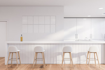 White pub interior with bar counter and stools