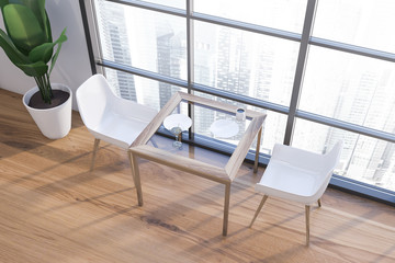 Square table in white cafe interior, top view