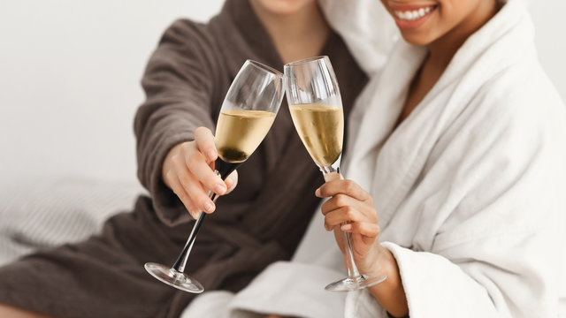 Cropped of spa ladies holding glasses with champagne