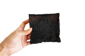 Burnt bread in hand isolated on white background, slice toast, mistake or fail, hard life, sadness, unhappy, tough life, unsuccessful in cooking, wasted time, low self-esteem concept