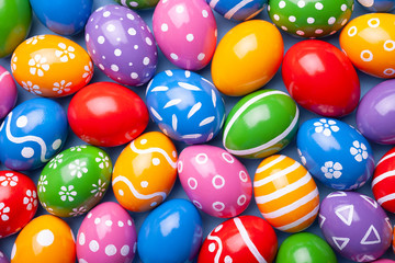 Easter eggs as background. Top view of decorated eggs on color background