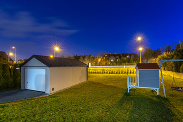 New garage in the garden at night, Poland