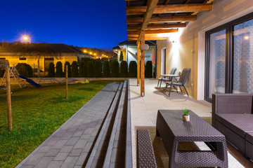 Home terrace with a roof in the night scenery of the garden
