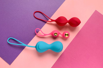 Sex toys for woman. Three geisha balls on a color background. Useful for sex shop, adults.