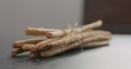 bunch of homemade grissini on concrete countertop