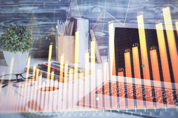 Stock market chart hologram drawn on personal computer background. Double exposure. Concept of investment.