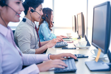Group of young teamwork  businesspeople with headset and computer at office.