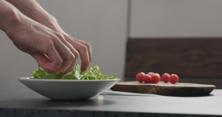 add frisee salad leaves into white bowl